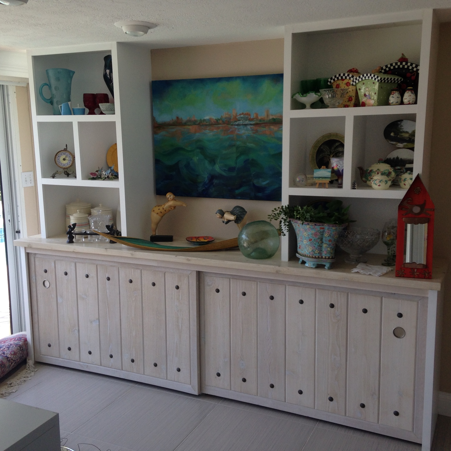 White built-in display shelves over a long bank of cabinets
